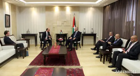 A handout picture released by Prime Minister Office shows Palestinian Prime Minister Rami Hamdallah meets with UN humanitarian coordinator James Rawley, in the West Bank city of Ramallah on April 9, 2015. Photo by Prime...