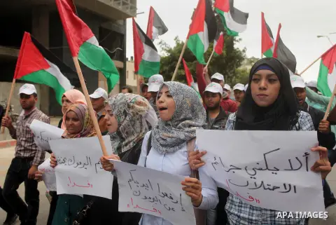 Palestinian factions take part a protest to show solidarity with the Palestinians living in Syria's Yarmouk camp, which is besieged by government forces and has been largely overrun by jihadist fighters, in Gaza city on...
