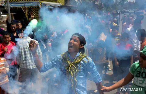 An Egyptian supporter of Muslim Brotherhood and ousted president Mohammed Morsi, lights flares during a protest against military rule in al-Matariya district, near Cairo on April 10, 2015. Photo by Amr Sayed