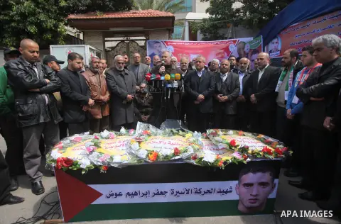 Palestinians take part in a symbolic funeral for the former Palestinian prisoner Jaafar Awad, who was recently released from Israeli jail, in front of Red cross office in Gaza city on April 11, 2015. Israeli troops shot...