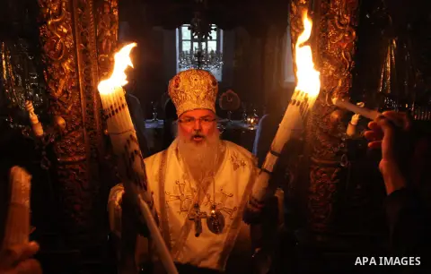 Christian pilgrims hold candles at the church of the Holy Sepulcher, traditionally believed to be the burial site of Jesus Christ, during the ceremony of the Holy Fire in in Bethlehem City, on April 11, 2015. Thousands o...
