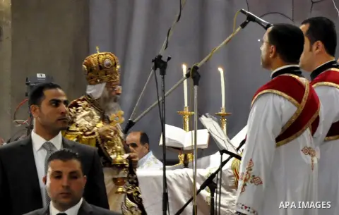 Coptic Pope Tawadros II, head of the Coptic Orthodox church, takes part in a ritual as part of a Coptic Orthodox Easter mass at the main cathedral in Cairo April 11, 2015. Photo by Amr Sayed