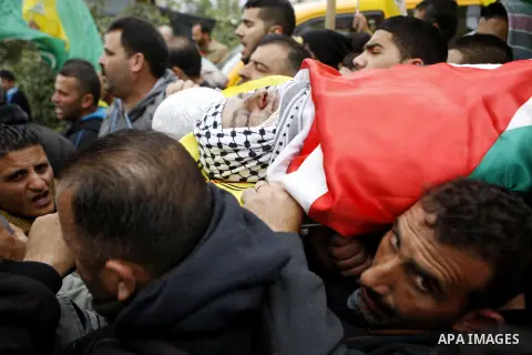 Mourners carry the body of 27-year-old Palestinian Mohammed Jasser Karakra, during his funeral in the Sinjil village, in the occupied West Bank city of Ramallah, on April 13, 2015. Karakra stabbed two Israeli soldiers in...
