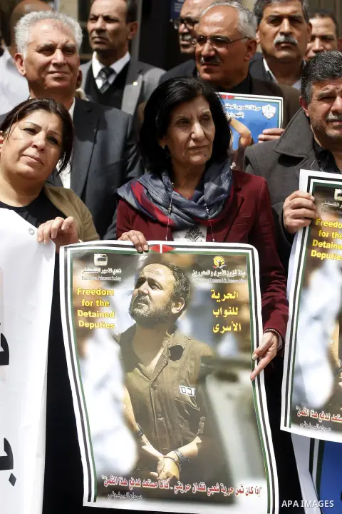 Palestinians hold portraits of jailed Fatah leader Marwan Barghouti during a protest demanding for his release form Israeli prison, outside the Palestinian legislative council in the West Bank city of Ramallah, April 15,...