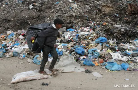 A Palestinian boy carries recyclables collected from the garbage near the border with Israel, east of Rafah town, in the southern Gaza Strip, April 16, 2015. Workers collect the household recyclables, metals and plastic...