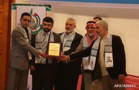 Senior Hamas leader Ismail Haniyeh honors the relatives of former Hamas leader Abdel Aziz al-Rantissi during a ceremony marking the eleventh anniversary of his death, in Khan Younis in the southern Gaza Strip, on April 1...