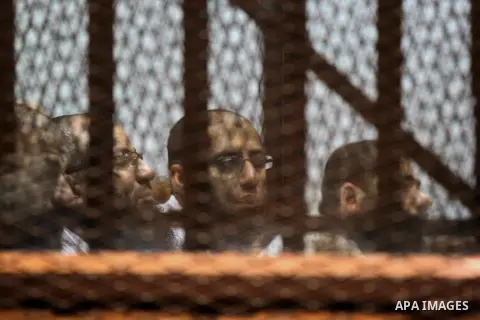 Egyptian suspects in the case of Suez terrorist cell sit inside court's cage during their trial, at a court, in Cairo, Egypt on April 18, 2015. Photo by Amr Sayed