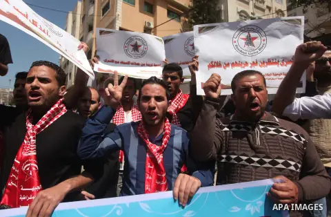 Protesters take part in a protest marking Palestinian Prisoners' Day in front of Red cross office in Gaza City April 19, 2015. Palestinian human rights groups say 6,000 Palestinian prisoners remain in Israeli prisons and...