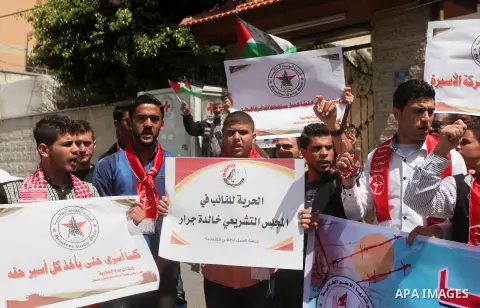 Protesters take part in a protest marking Palestinian Prisoners' Day in front of Red cross office in Gaza City April 19, 2015. Palestinian human rights groups say 6,000 Palestinian prisoners remain in Israeli prisons and...