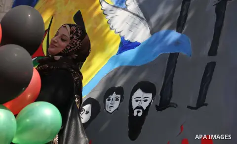 Protesters take part in a protest marking Palestinian Prisoners' Day in front of Red cross office in Gaza City April 19, 2015. Palestinian human rights groups say 6,000 Palestinian prisoners remain in Israeli prisons and...