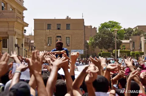 Egyptian students who support ousted President Mohamed Morsi and the Muslim Brotherhood, shout slogans during a demonstration at Cairo University on April 19, 2015. Administrative security personnel in Cairo University a...