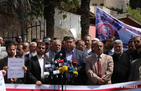 Palestinian employees of former Palestinian government take part a protest demanding their salaries to be paid, in front of the headguarter of the Council of Ministers in Gaza city on April 21, 2015. Photo by Mohammed As...