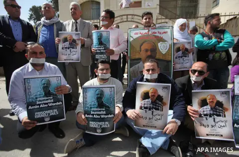 Palestinian Journalests hold banners during a protest calling for their fellow the Journalist Amin Abu Warda held in Israeli jails outside the International Red Cross offices in the West bank city of Nablus on April 21,...