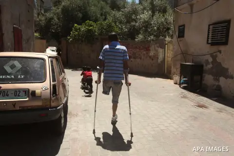 Palestinian artist Jihad Al-Ghoul, 23, walks outside his house in Bureij refugee camp in the center Gaza Strip, on April 25, 2015. Al-Ghoul said that he lost his leg in an Israeli attacked on Bureij refugee camp in 2008....