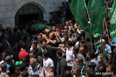 Relatives carry the body of Palestinian Mahmud Abu Jhaisha during his funeral, in the West Bank city of Hebron on April 26, 2015. Mahmud Abu Jhaisha, in his 20s, died on the way to a hospital after he was shot by Israeli...
