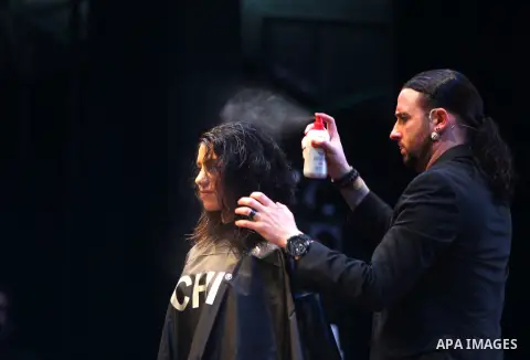 A Palestinian model gets her hair done by international stylist Bradley Tuggle, from Farouk Systems, makers of CHI Haircare, during the opening ceremony of Farouk systems in the West Bank city of Ramallah, on April 27, 2...