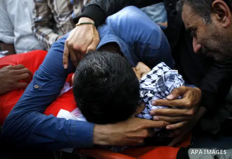Relatives mourn over the body of Palestinian Mohammad Saleh, 18, during his funeral in the West Bank village of Alaraqa near Jenin April 28, 2015. Saleh shot by Israeli soldiers in the occupied West Bank died of his woun...