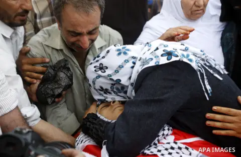 Relatives mourn over the body of Palestinian Mohammad Saleh, 18, during his funeral in the West Bank village of Alaraqa near Jenin April 28, 2015. Saleh shot by Israeli soldiers in the occupied West Bank died of his woun...