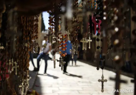 Palestinians and tourists walk at the market outside the al-Aqsa mosque compound, in Jerusalem's old city on May 1, 2015. Photo by Saeb Awad