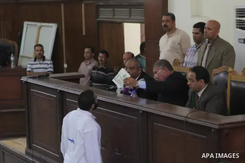 A suspect of of Ansar Bait Al-Maqdis group, attends his trial at a court in Cairo on May 3, 2015. Cairo criminal court Sunday adjourned the trial of 213 suspects of Ansar Bait Al-Maqdis group, on charges of assassination...