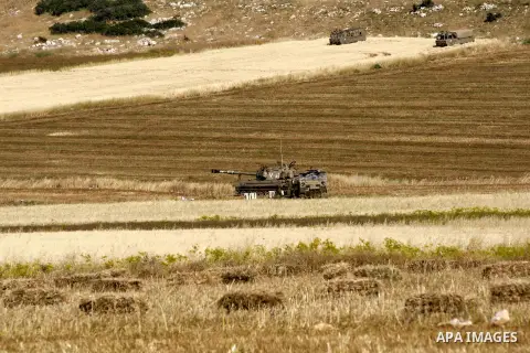 Israeli soldiers stand next to their vehicles during a military training in the Jordan valley, near the West Bank town of Tubas, on May 6, 2015. Besieged Palestinian communities in the occupied West Bank's Jordan Valley...
