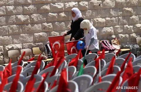 Palestinians hold Turkish flags during the opening ceremony of the Nablus Rashidiya girls school, in the West Bank city of Nablus, on May 7, 2015. The Nablus Resadiye girls school in Palestine was established in 1911. TI...