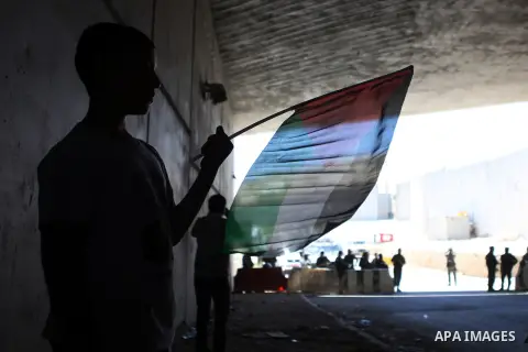 Palestinian protesters from the East Jerusalem village of al-Zaim, wave Palestinian flags as they confront Israeli Border Police during a protest demanding the opening of the only gate in the separated barrier leading fr...
