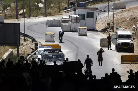 Palestinian protesters from the East Jerusalem village of al-Zaim, wave Palestinian flags as they confront Israeli Border Police during a protest demanding the opening of the only gate in the separated barrier leading fr...