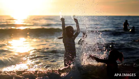 Palestinians enjoy their time during sunset at the beach of Gaza sea on Mat 8, 2015. Photo by Mohammed Talatene