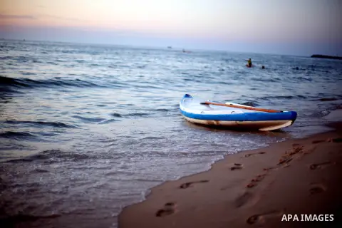 Palestinians enjoy their time during sunset at the beach of Gaza sea on Mat 8, 2015. Photo by Mohammed Talatene