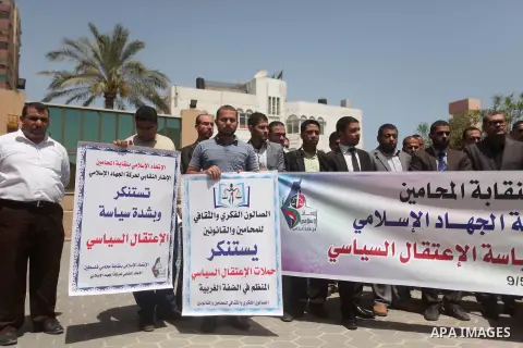 Palestinian lawyers hold banners during a protest against the political arrests in the West Bank, in Gaza city on May 9, 2015. Photo by Ashraf Amra
