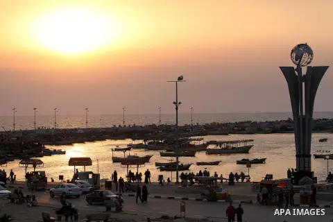 Palestinians enjoy their time during sunset at the beach of Gaza sea on May 9, 2015. Photo by Mohammed Asad