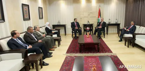 Palestinian Prime Minister, Rami Hamdallah, receives the annual report of the Office of Financial and Administrative Control in the West Bank city of Ramallah on May 11 , 2015. Photo by Prime Minister Offic