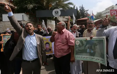 Palestinian families of martyrs take part a protest to demand their rights, in front of the headquarters of the Council of Ministers in Gaza city, on May 12, 2015. Photo by Yasser Qudih