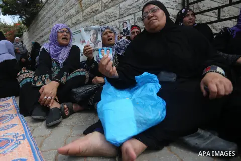 Palestinian families of martyrs take part a protest to demand their rights, in front of the headquarters of the Council of Ministers in Gaza city, on May 12, 2015. Photo by Yasser Qudih
