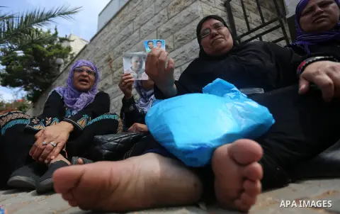 Palestinian families of martyrs take part a protest to demand their rights, in front of the headquarters of the Council of Ministers in Gaza city, on May 12, 2015. Photo by Yasser Qudih