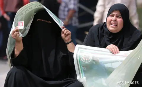 Palestinian families of martyrs take part a protest to demand their rights, in front of the headquarters of the Council of Ministers in Gaza city, on May 12, 2015. Photo by Yasser Qudih