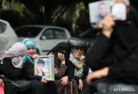 Palestinian families of martyrs take part a protest to demand their rights, in front of the headquarters of the Council of Ministers in Gaza city, on May 12, 2015. Photo by Yasser Qudih