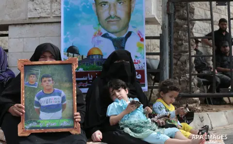 Palestinian families of martyrs take part a protest to demand their rights, in front of the headquarters of the Council of Ministers in Gaza city, on May 12, 2015. Photo by Yasser Qudih