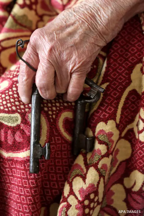 Palestinian refugee Kamela Safi, 90, holds the keys of her former house in the village of Biet Nabal as she sits at her home in the West Bank refugee camp of Jalazon, north of Ramallah om May 12, 2015. ''Nakba'' means in...