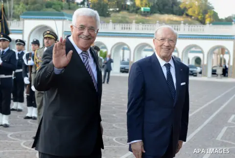 Tunisian President Beji Caid Essebsi and Palestinian president Mahmud Abbas review the honour guard during a welcome ceremony at the Carthage Palace in Tunis, on May 12, 2015. Abbas is on a three day official visit to Tu...