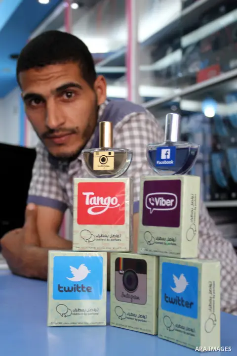 A Palestinian man displays perfumes in social media marks , at his shop in Khan Younis in the southern Gaza Strip, May 13, 2015. In a report on Internet freedom included 20 Arab countries, Palestine and Tunisia relativel...