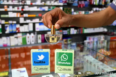A Palestinian man displays perfumes in social media marks , at his shop in Khan Younis in the southern Gaza Strip, May 13, 2015. In a report on Internet freedom included 20 Arab countries, Palestine and Tunisia relativel...
