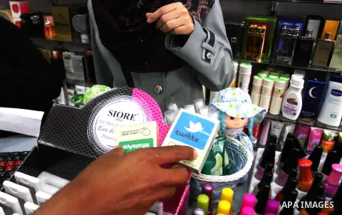 A Palestinian man displays perfumes in social media marks , at his shop in Khan Younis in the southern Gaza Strip, May 13, 2015. In a report on Internet freedom included 20 Arab countries, Palestine and Tunisia relativel...