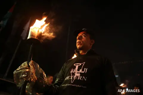Palestinian hold torches during a rally ahead of the commemorations of the 67th anniversary of the ''Nakba'', in the West Bank city of Ramallah on May 14, 2015. ''Nakba'' means in Arabic ''catastrophe'' in reference to t...