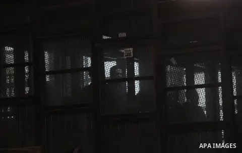 Egyptian radical Islamist Mohammed al-Zawahiri, the brother of Al-Qaeda chief Ayman al-Zawahiri, sits in the defendants cage during his trial, at a court in Cairo on May 17, 2015. Photo by Amr Sayed