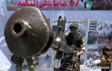 Palestinian militants of the Ezzedine al-Qassam Brigades, Hamas' armed wing, take part in a parade in the southern Gaza Strip town of Rafah on May 17, 2015 to mark the 67th anniversary of the "Nakba". "Nakba" means in Ar...