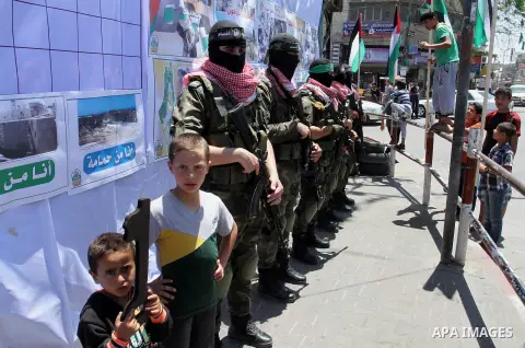 Palestinian militants of the Ezzedine al-Qassam Brigades, Hamas' armed wing, take part in a parade in the southern Gaza Strip town of Rafah on May 17, 2015 to mark the 67th anniversary of the "Nakba". "Nakba" means in Ar...