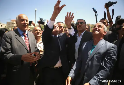 FIFA president Joseph Blatter (R) releases a dove as Palestine Football Association President Jibril Rajoub claps during his visit to the village of Dura al-Qaraa, near the West Bank city of Ramallah, on May 20, 2015. Bl...