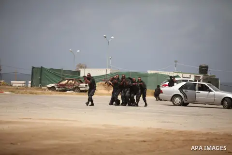 Palestinian security forces show their skills during a military training graduation ceremony in Gaza City on May 21, 2015. Photo by Ashraf Amra